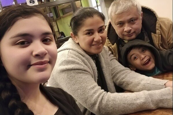 In this July 2020 photo, Xavier Chavarría, background right, poses for a photo with his wife Karen Chavarría, second left, and their children Karen Azriela Chavarria, left, and son Xavier Yahir Chavarría, in Jinotega, Nicaragua. (Courtesy Xavier Chavarría via AP)