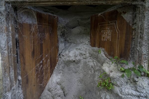 The sand-filled entrance of a house is visible in Chanaute Market, Melamchi, northeast of Kathmandu, Nepal, Sunday, Sept. 15, 2024, that was damaged by floods in 2021. (AP Photo/Niranjan Shrestha)