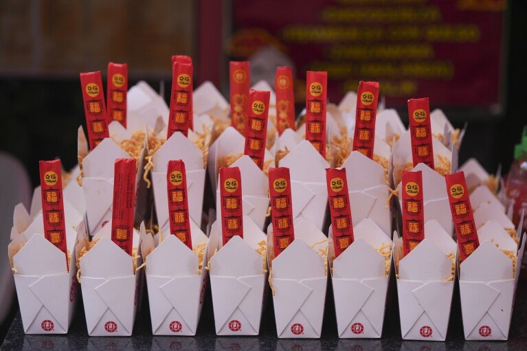 Fried noodles in takeaway boxes are displayed for sale in Chinatown, in Mexico City's historic center, Saturday, June 8, 2024. (AP Photo/Fernando Llano)