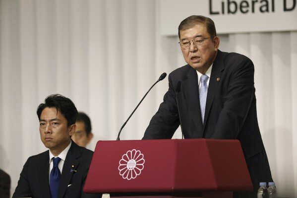 Japan's former Defense Minister Shigeru Ishiba, a candidate of Japan's ruling Liberal Democratic Party (LDP) presidential election, speaks next to another candidate former Environment Minister Shinjiro Koizumi during a joint news conference at the party's headquarters in Tokyo Friday, Sept. 13, 2024. (Franck Robichon/Pool Photo via AP)
