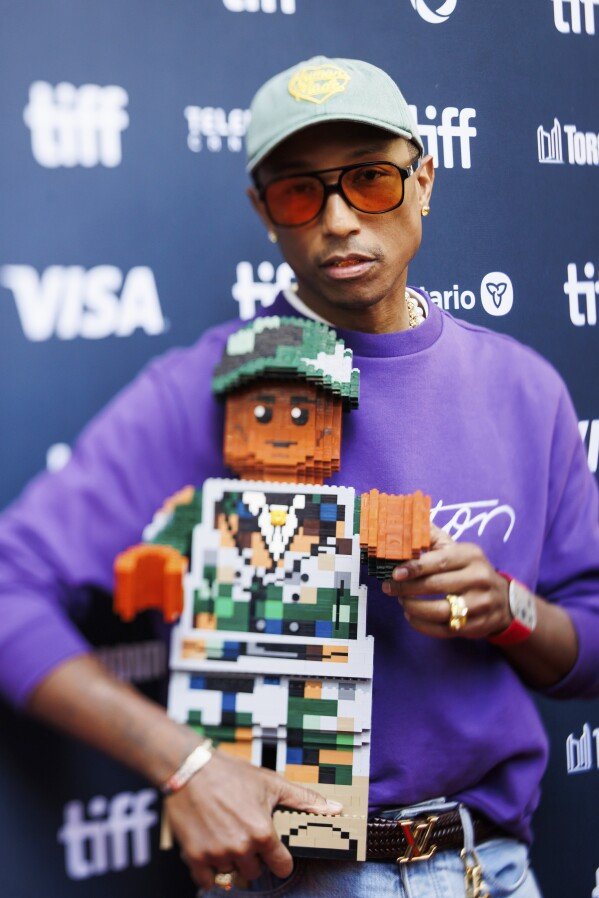 Pharrell Williams arrives on the red carpet for the premiere of 'Piece by Piece' at the Princess of Wales Theatre during the Toronto International Film Festival in Toronto, Tuesday, Sept. 10, 2024. (Cole Burston/The Canadian Press via AP)