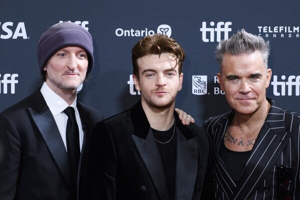 Director Michael Gracey, Jonno Davies and Robbie Williams attend the premiere of "Better Man", during the 2024 Toronto International Film Festival, in Toronto on Monday, Sept. 9, 2024. (Christopher Katsarov/The Canadian Press via AP)