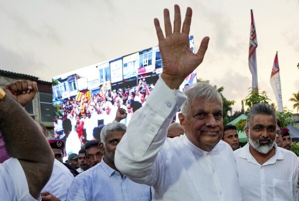 FILE - Sri Lankan President Ranil Wickremesinghe waves to supporters as he arrives to address a public election rally in Minuwangoda, Sri Lanka, Tuesday, Sept. 17, 2024. (AP Photo/Rajesh Kumar Singh, File)