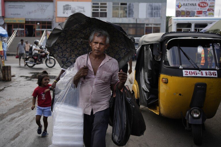 A man sells plastic bags on a street in Colombo, Sri Lanka, Friday, Sept. 13, 2024. (AP Photo/Eranga Jayawardena)