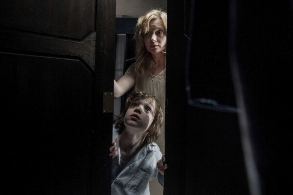 This image released by IFC Films shows Noah Wiseman, bottom, and Essie Davis in a scene from the film "The Babadook." (IFC Films via AP)