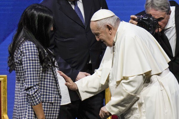 Pope Francis greets a pregnant woman at the end of a conference to discuss the "demographic winter" and "empty cribs" problem Italy is facing, at Auditorium della Conciliazione, in Rome, May 12, 2023. (AP Photo/Alessandra Tarantino, File)