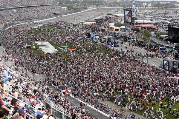 Fans fill the infield during activities before the NASCAR Daytona 500 auto race at Daytona International Speedway, Feb. 19, 2023, in Daytona Beach, Fla. (AP Photo/David Graham, File)