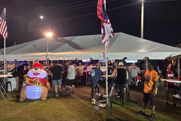 NASCAR fans party at the Red 38 bar at the Daytona International Speedway infield. Wednesday, Feb 12, 2025 in Daytona Beach , Fla (AP Photo/ Mark Long)