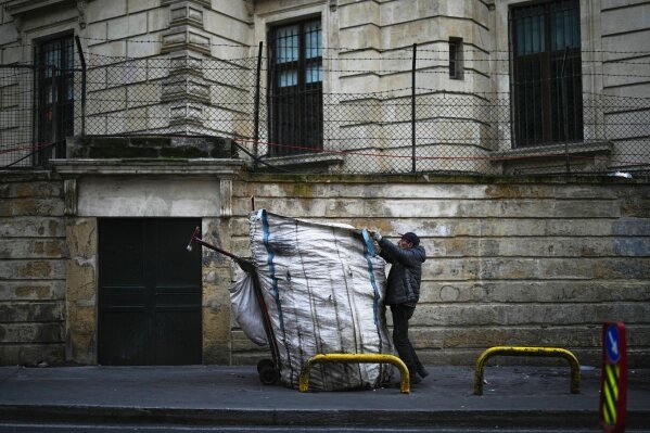 A garbage collector loads his cart with plastic bottles in Cihangir neighborhood in Istanbul, Turkey, Wednesday, Jan. 29, 2025. (AP Photo/Francisco Seco)