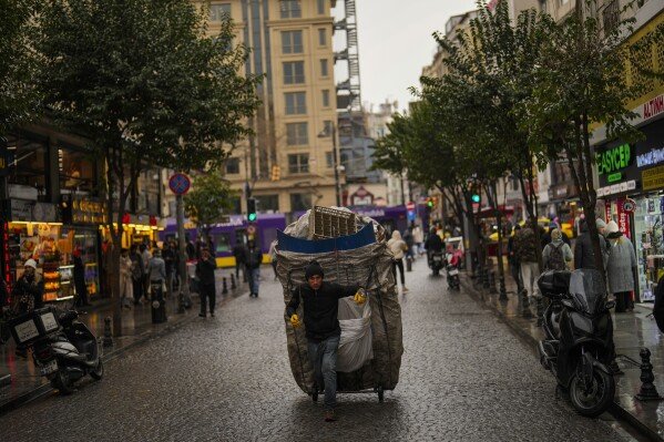A man pulls his cart full with plastic items at Sirkeci area in Istanbul, Turkey, Thursday, Feb. 6, 2025. (AP Photo/Francisco Seco)